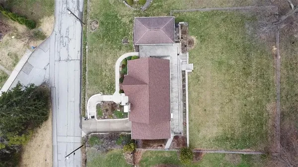 an aerial view of a house with garden space and street view