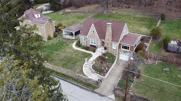 a front view of a house with a yard and outdoor seating