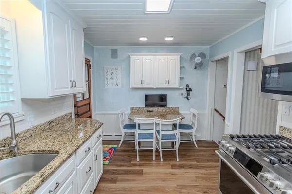 a kitchen with stainless steel appliances granite countertop a sink stove and refrigerator