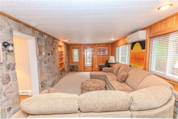 a bedroom with a bed a couch and dresser