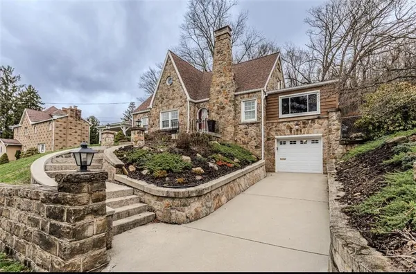 a front view of a house with garden