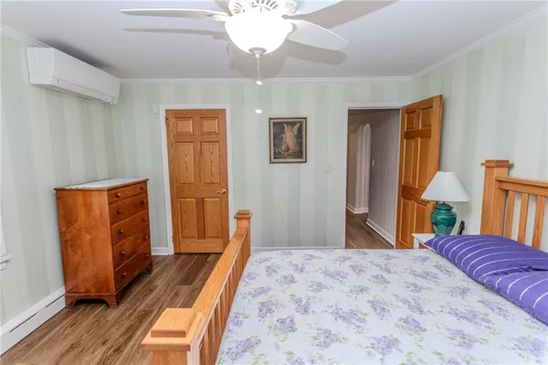 a dining room with furniture entryway and wooden floor