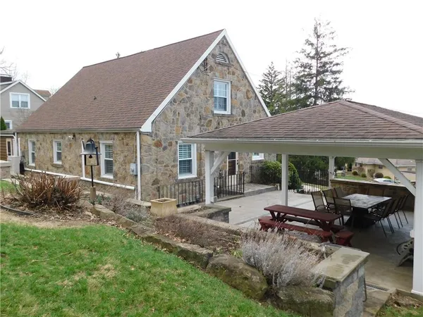 a view of a house with sitting area and garden