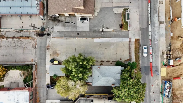 an aerial view of a residential apartment building with a yard and seating space