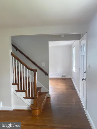 a view of entryway and hall with wooden floor