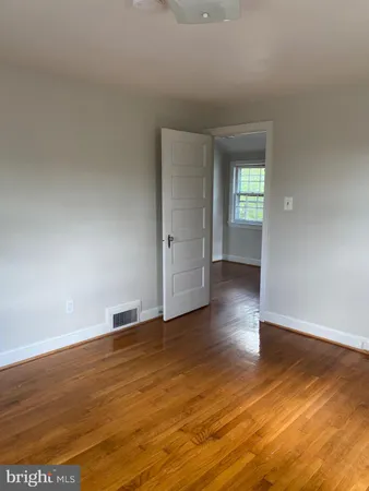 a view of wooden floor and windows in an empty room