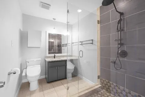 a bathroom with a toilet sink and shower