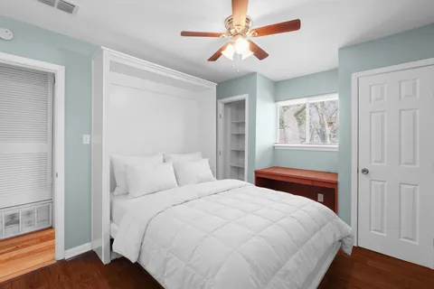a bedroom with a large bed and a chandelier