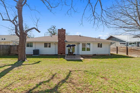 a view of a house with swimming pool and a yard