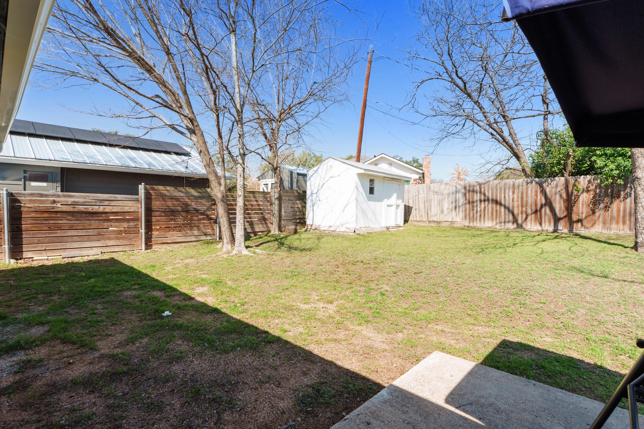 2312 Rogge Lane Austin, TX 78723 - Photo 31 of 34 Fenced backyard with a storage shed