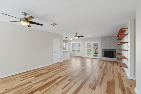 wooden floor in an empty room with a fireplace
