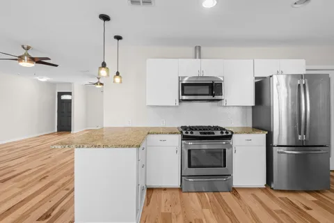 a kitchen with a stove and a refrigerator