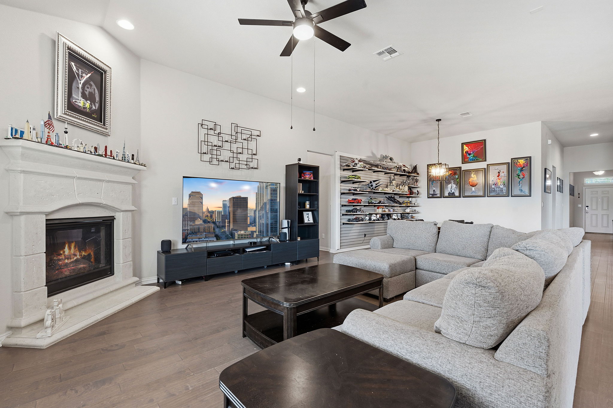 12616 Twisted Root Drive Manchaca, TX 78652 - Photo 8 of 36 Inside, soaring ceilings, warm wood flooring, recessed lighting, and oversized windows create a bright, easy energy throughout the open-concept layout.