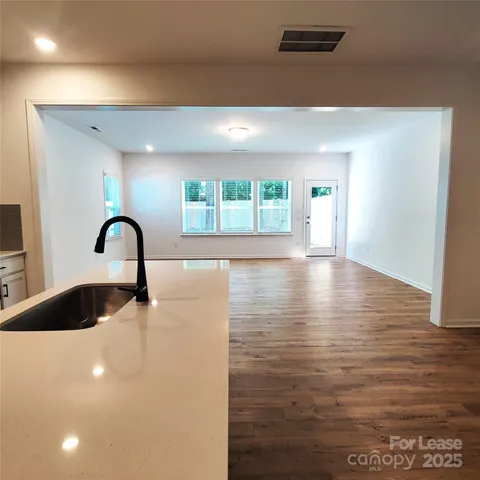 a view of a room with wooden floor and window