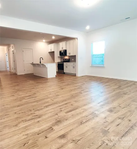 a view of a kitchen with microwave and cabinets