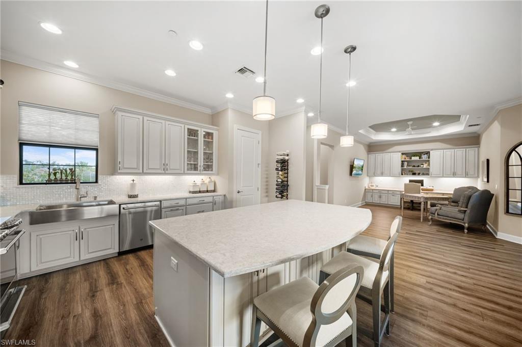 9672 Montelanico Loop, Unit 203 Naples, FL 34119 - Photo 12 of 49 a large kitchen with a table and chairs