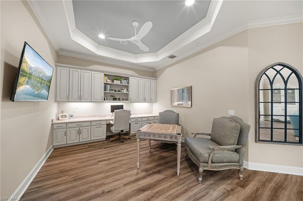 9672 Montelanico Loop, Unit 203 Naples, FL 34119 - Photo 13 of 49 a living room with furniture and a wooden floor