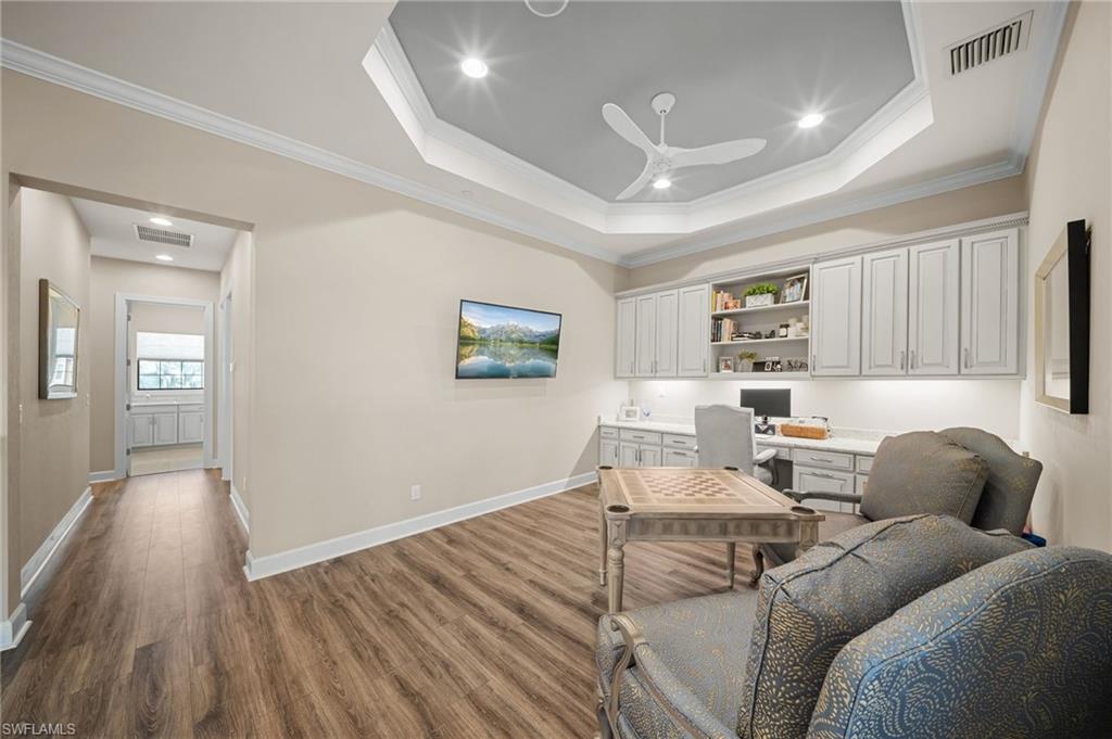 9672 Montelanico Loop, Unit 203 Naples, FL 34119 - Photo 14 of 49 a living room with furniture and a wooden floor