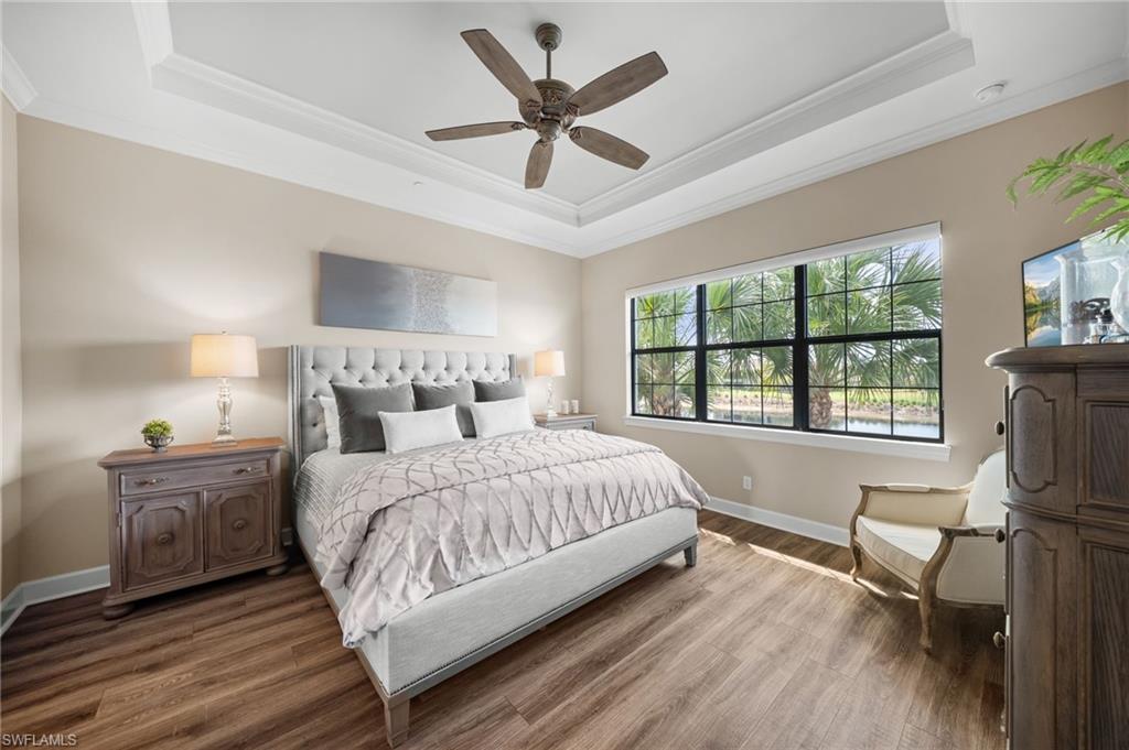 9672 Montelanico Loop, Unit 203 Naples, FL 34119 - Photo 15 of 49 a bedroom with a large bed and a large window