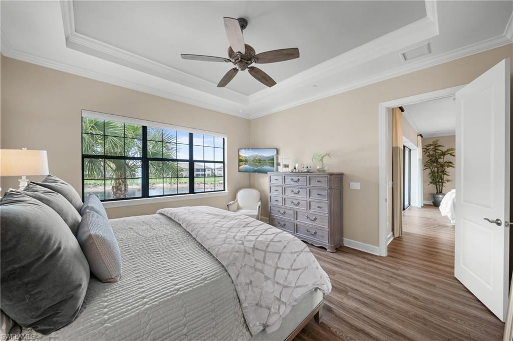9672 Montelanico Loop, Unit 203 Naples, FL 34119 - Photo 16 of 49 a bed room with a bed and a large window