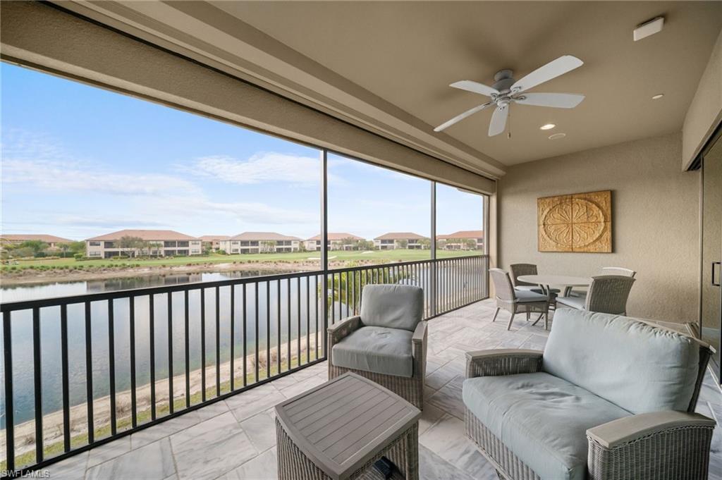 9672 Montelanico Loop, Unit 203 Naples, FL 34119 - Photo 25 of 49 a balcony with furniture and a ceiling fan