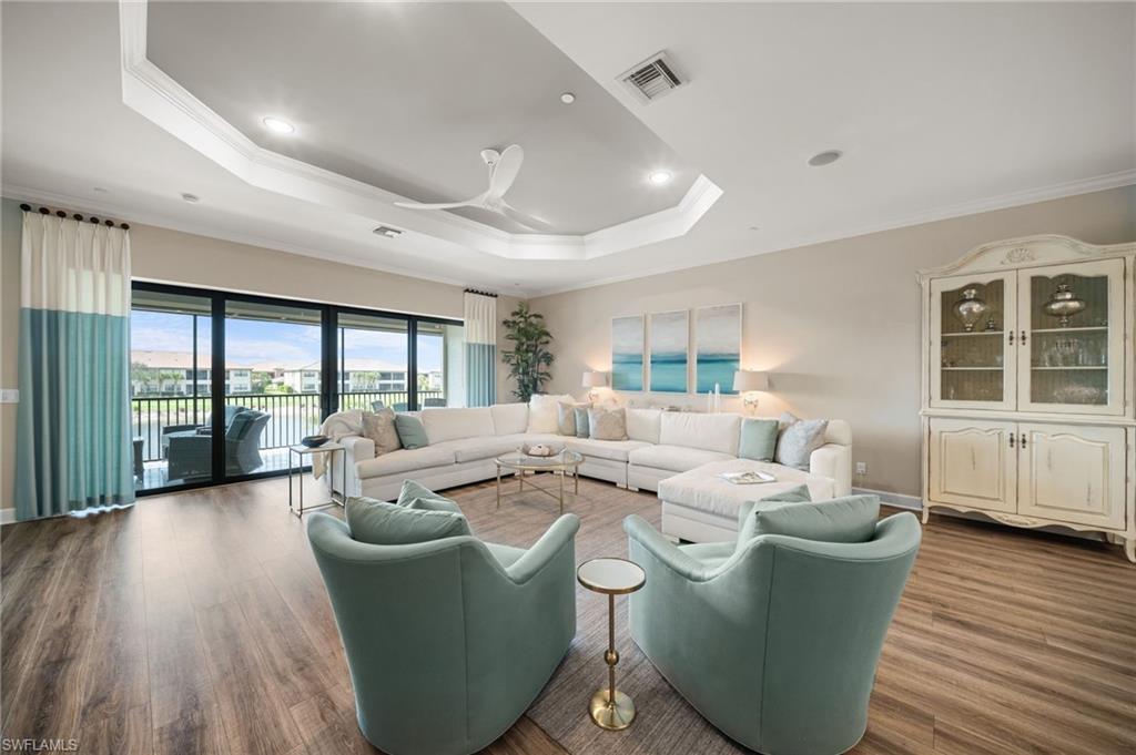 9672 Montelanico Loop, Unit 203 Naples, FL 34119 - Photo 5 of 49 a living room with furniture and large windows