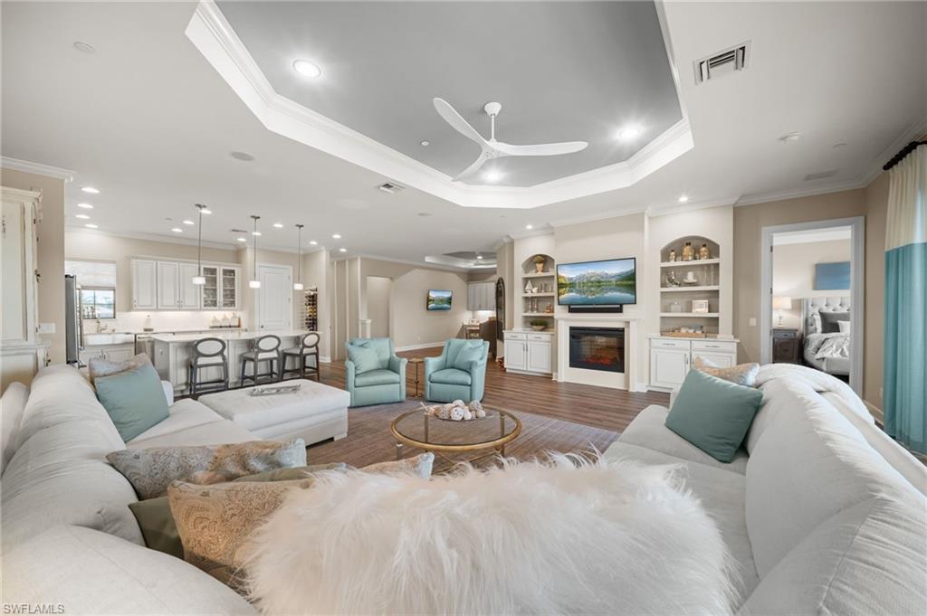 9672 Montelanico Loop, Unit 203 Naples, FL 34119 - Photo 7 of 49 a living room with furniture and a large window