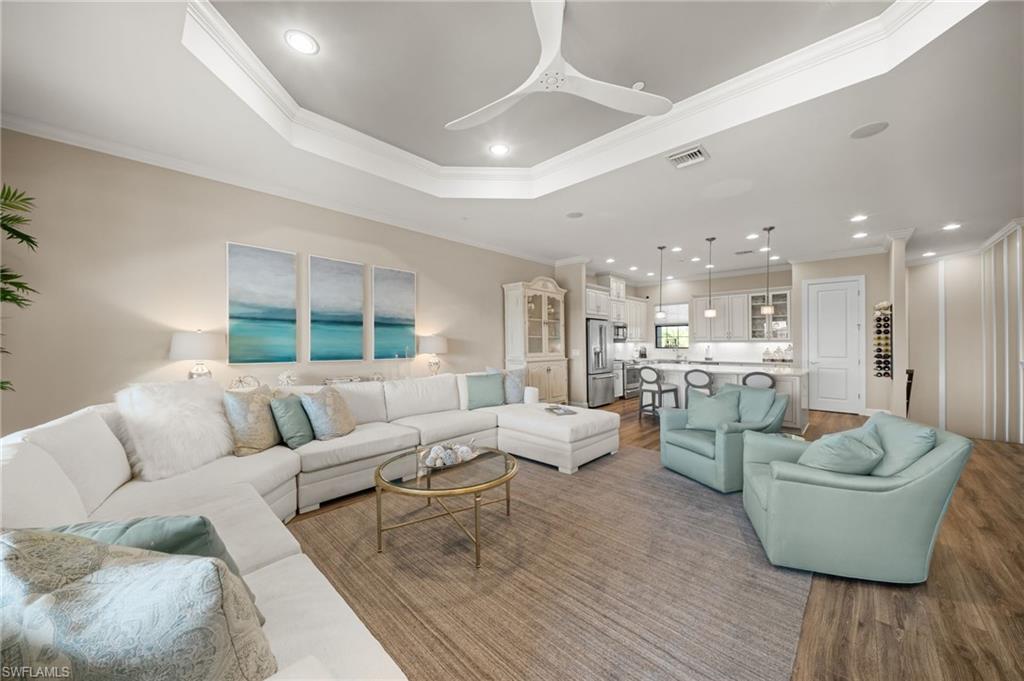 9672 Montelanico Loop, Unit 203 Naples, FL 34119 - Photo 8 of 49 a living room with furniture and a wooden floor