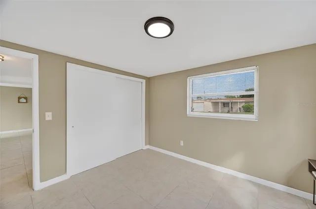 an empty room with closet area