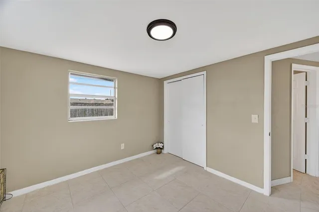 a view of a bedroom with wooden floor and chandelier fan