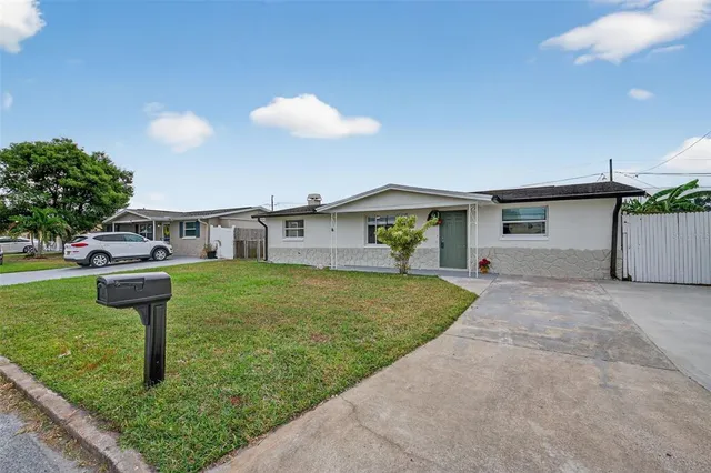 a view of a house with a yard and garage