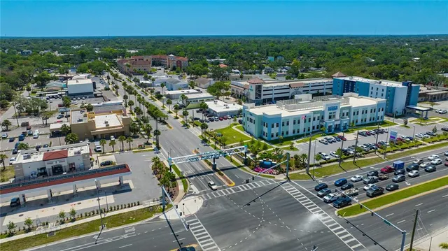a front view of multiple houses with yard