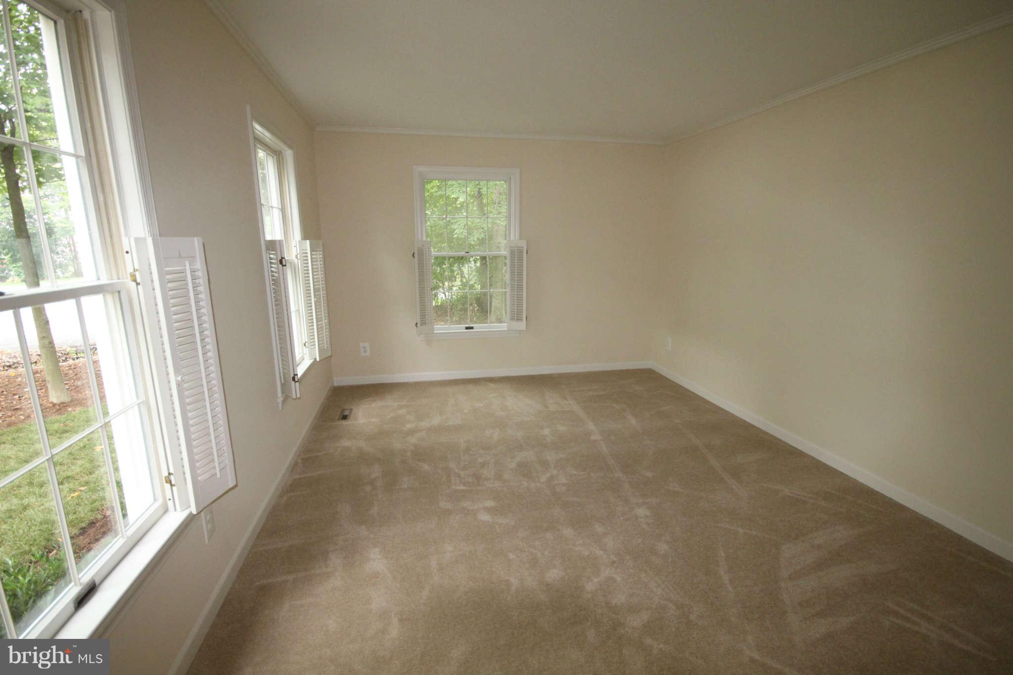 7510 Gambrill Road Springfield, VA 22153 - Photo 12 of 30 an empty room with wooden floor and windows