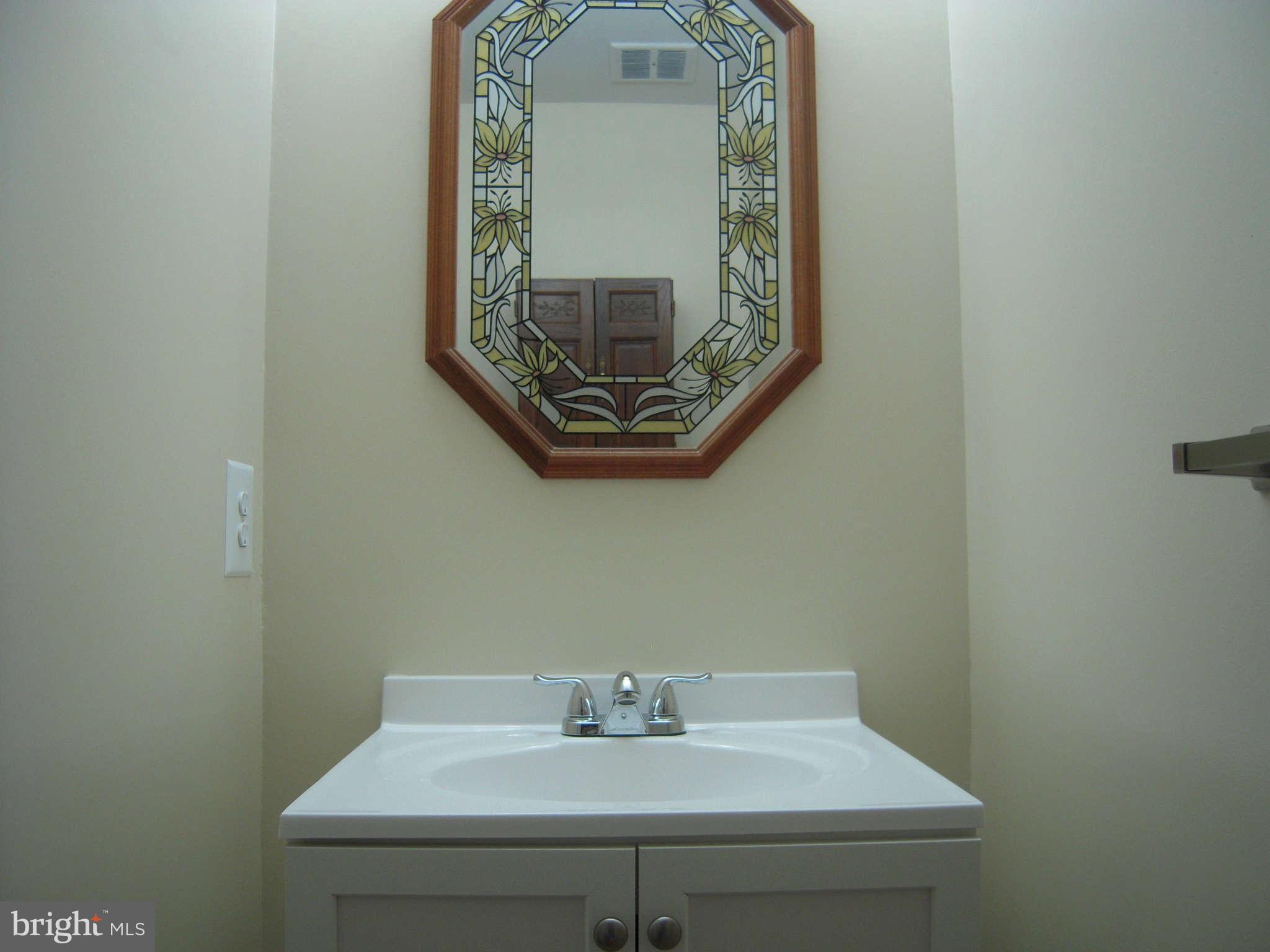 7510 Gambrill Road Springfield, VA 22153 - Photo 13 of 30 a bathroom with a sink and a mirror