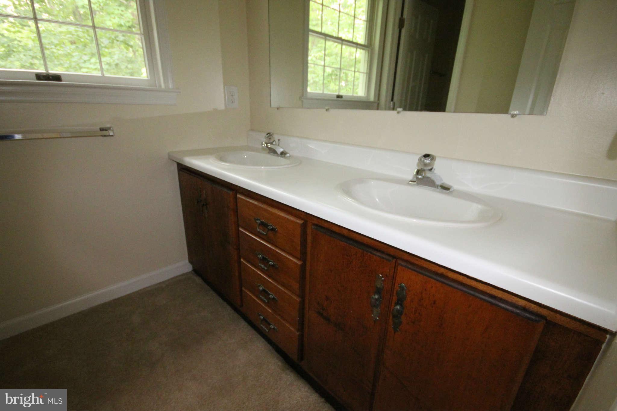 7510 Gambrill Road Springfield, VA 22153 - Photo 17 of 30 a bathroom with a double vanity sink and mirror