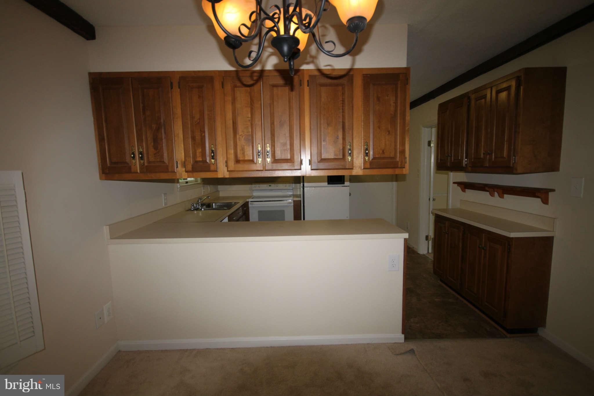 7510 Gambrill Road Springfield, VA 22153 - Photo 27 of 30 a kitchen with a refrigerator and a microwave