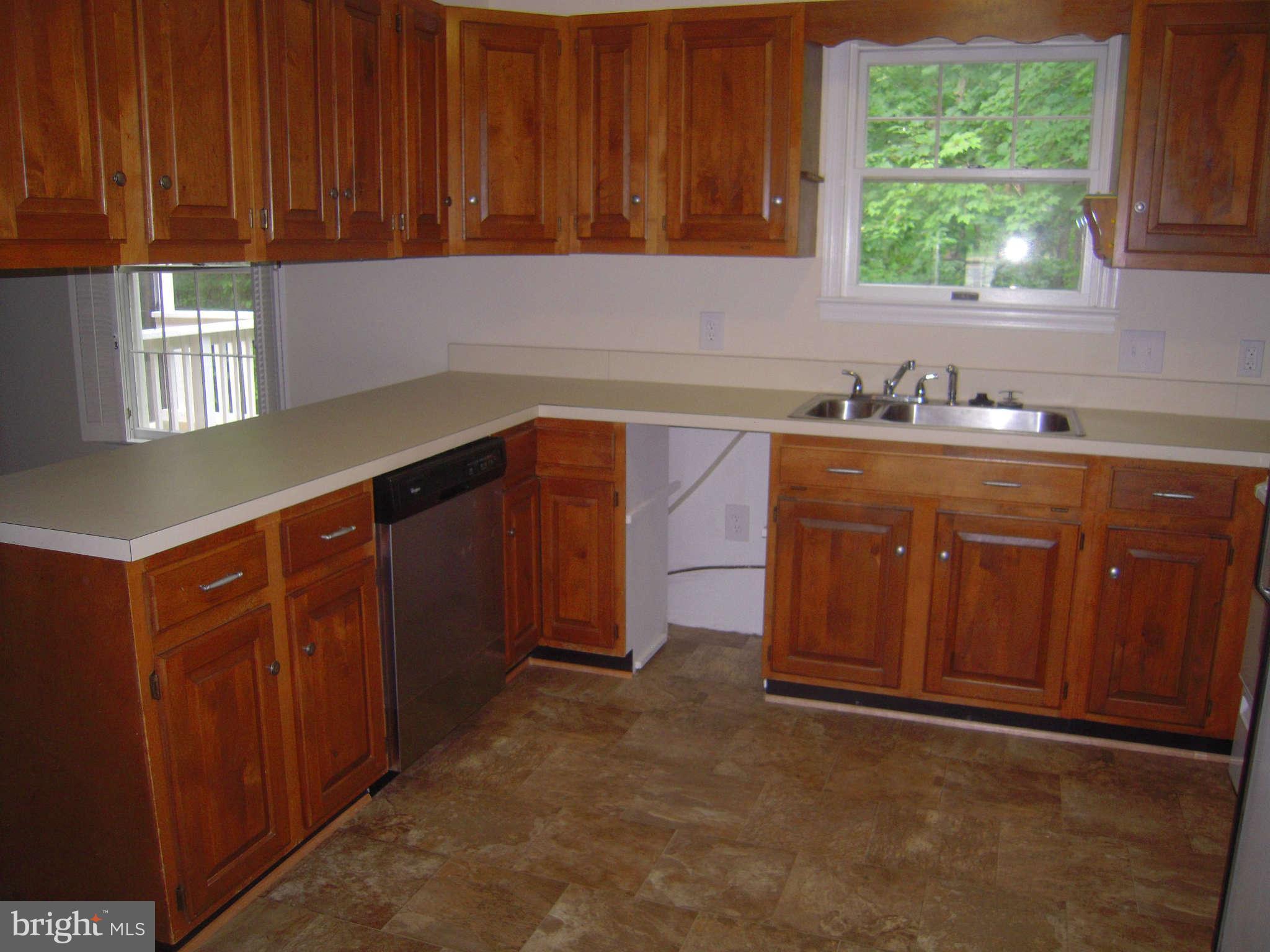 7510 Gambrill Road Springfield, VA 22153 - Photo 28 of 30 a kitchen with a sink window and cabinets