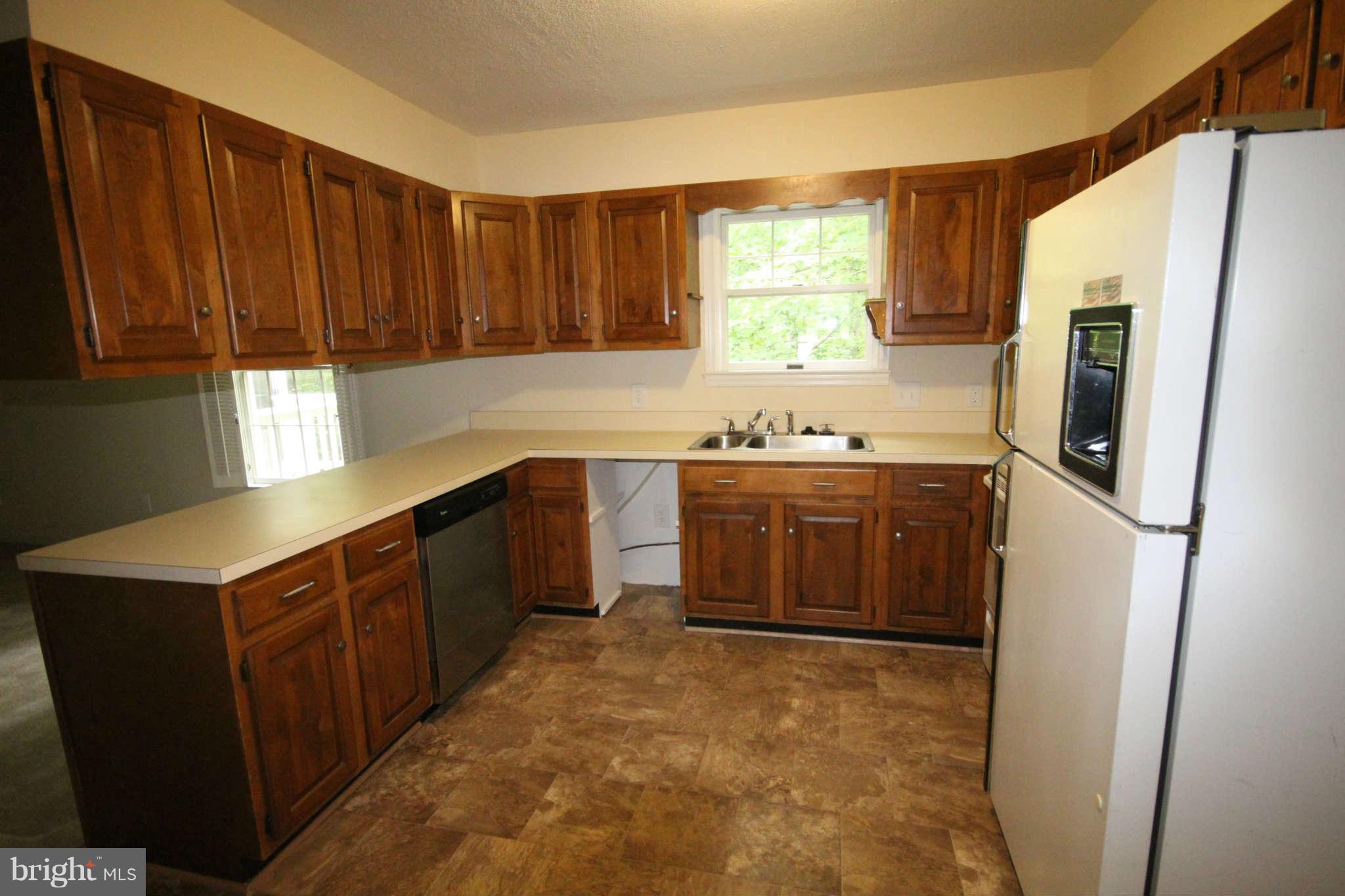 7510 Gambrill Road Springfield, VA 22153 - Photo 29 of 30 a kitchen with stainless steel appliances a sink a stove a refrigerator a window