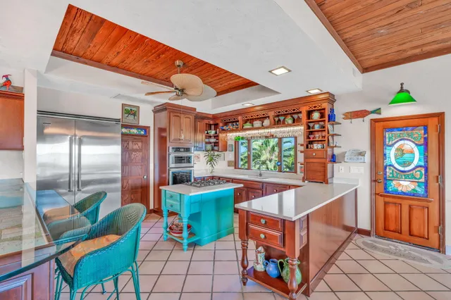 a view of a chairs and table in patio with a barbeque