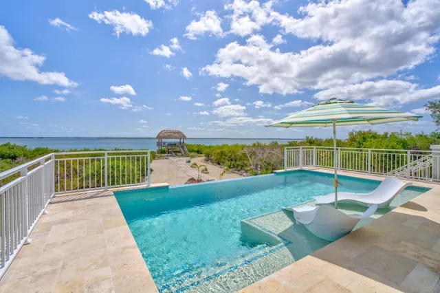 a view of balcony with wooden floor and fence