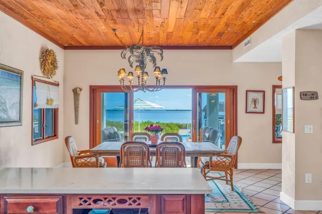 a view of a dining room with furniture a chandelier and wooden floor