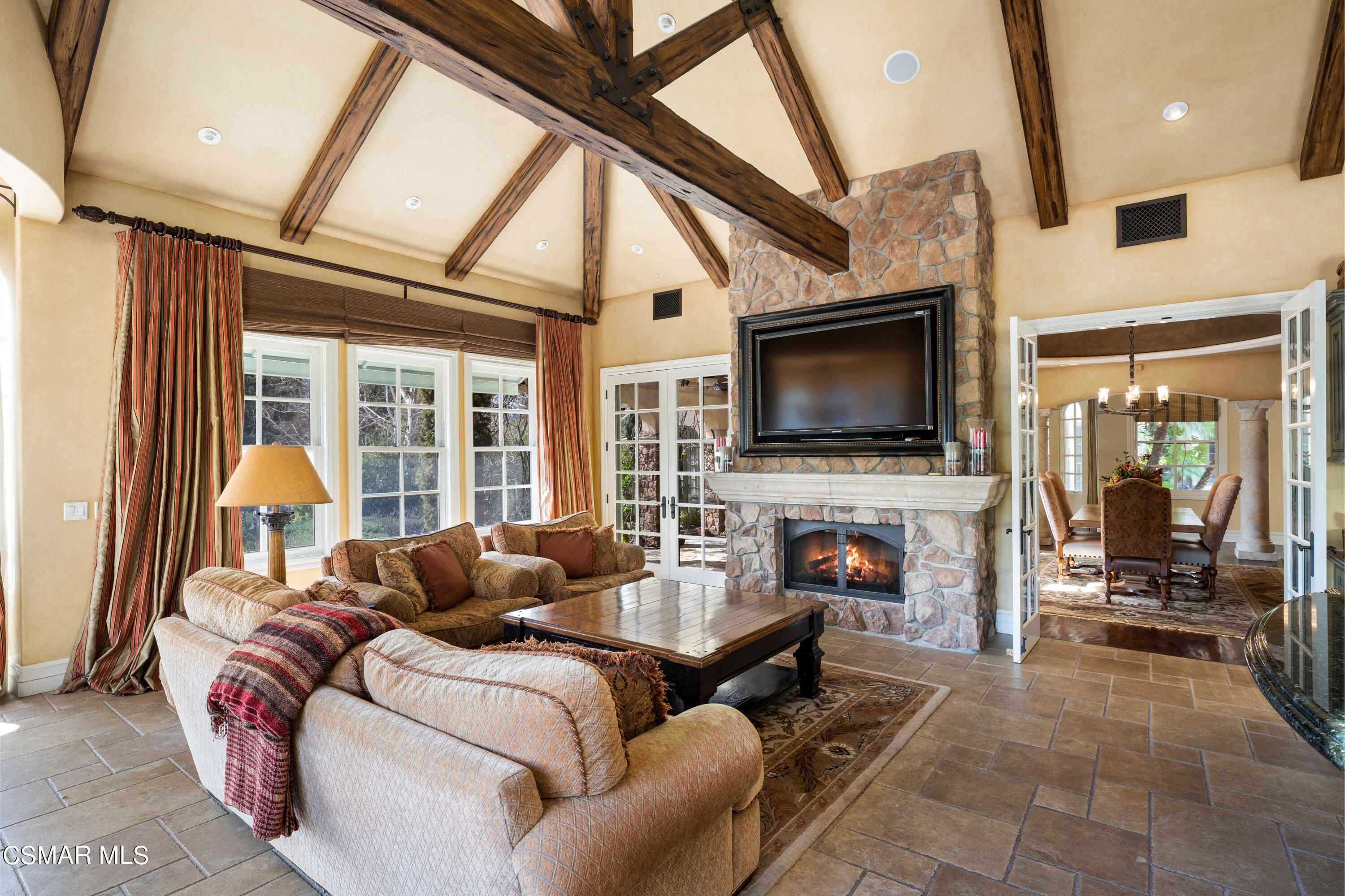 28685 Wagon Road Agoura Hills, CA 91301 - Photo 11 of 43 a living room with furniture a flat screen tv and a fireplace