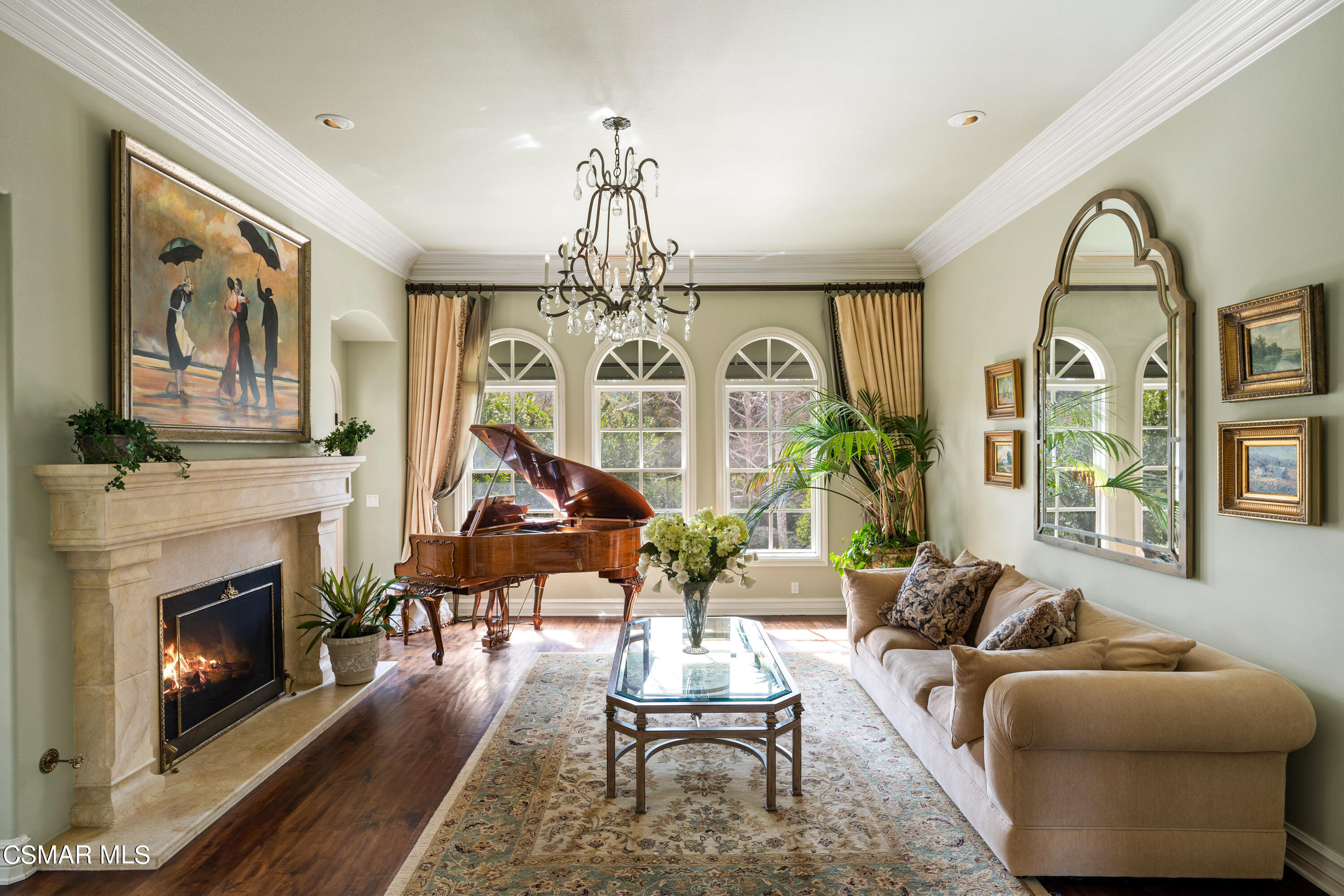 28685 Wagon Road Agoura Hills, CA 91301 - Photo 13 of 43 a living room with furniture a fireplace and a chandelier