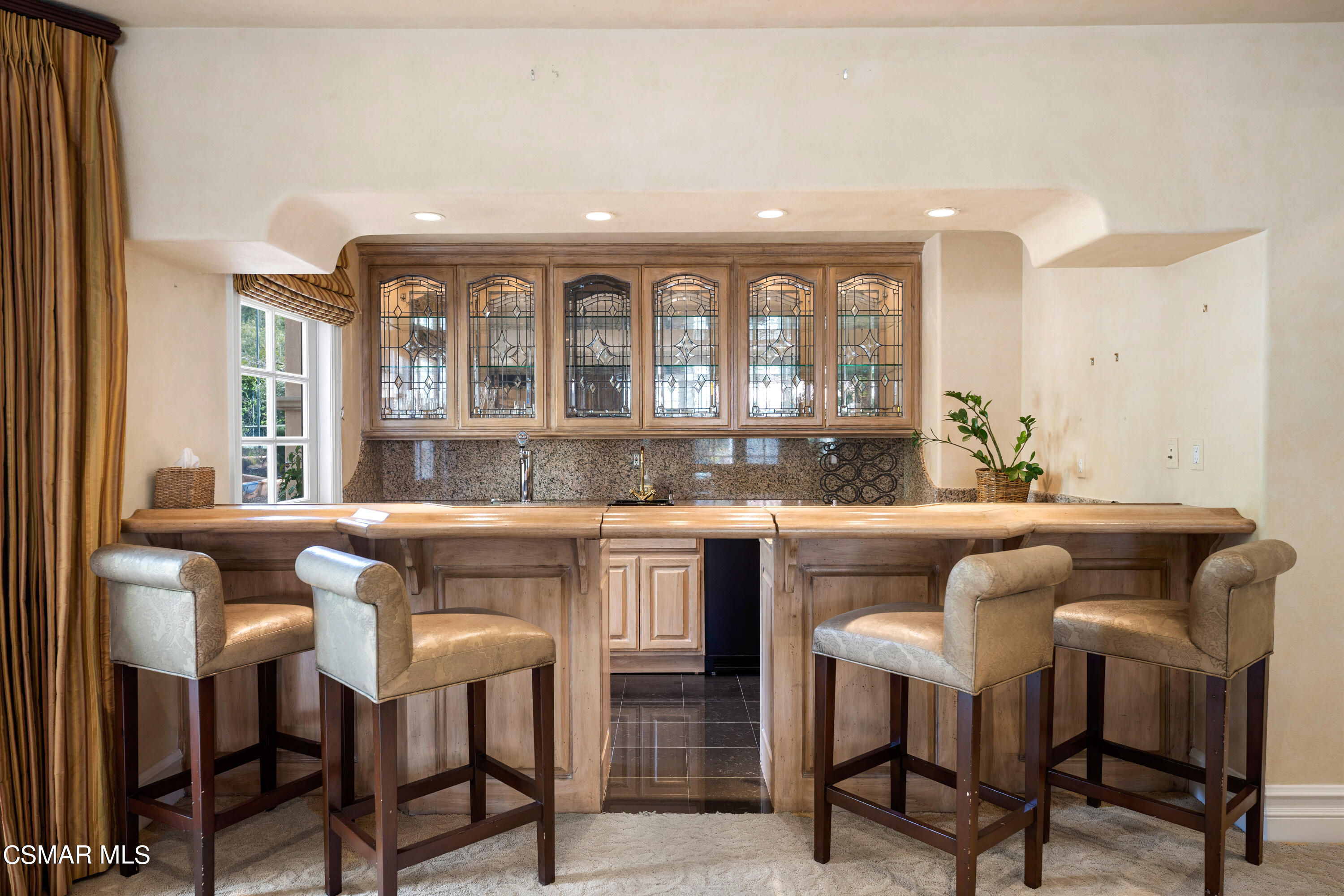 28685 Wagon Road Agoura Hills, CA 91301 - Photo 19 of 43 a kitchen with a dining table chairs and window