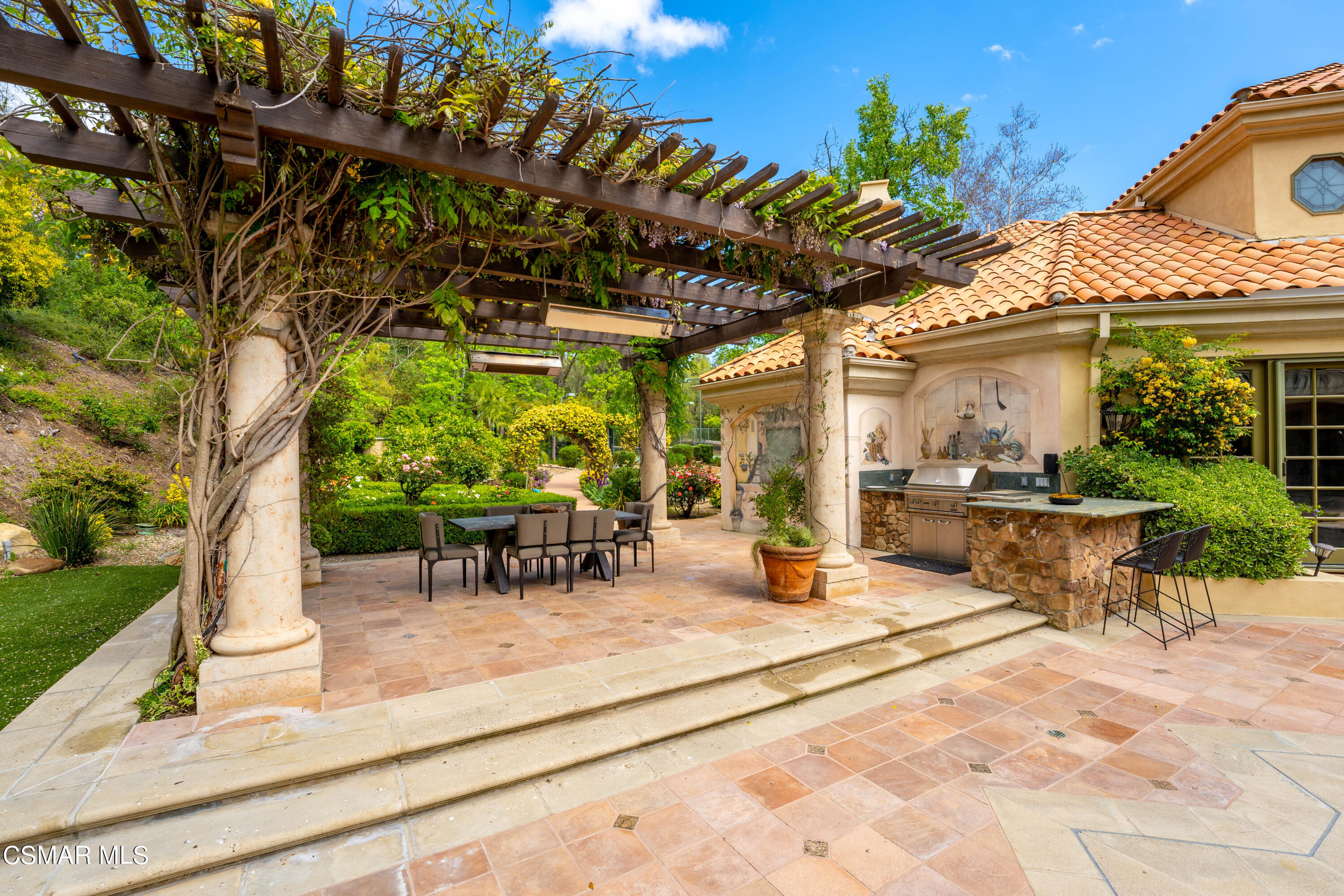 28685 Wagon Road Agoura Hills, CA 91301 - Photo 34 of 43 a view of a patio with a table and chairs under an umbrella