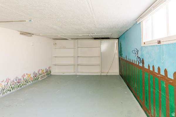 365 West 200 North Logan, UT 84321 - Photo 22 of 45 Room with built-in shelving, a single window, and a painted mural wall