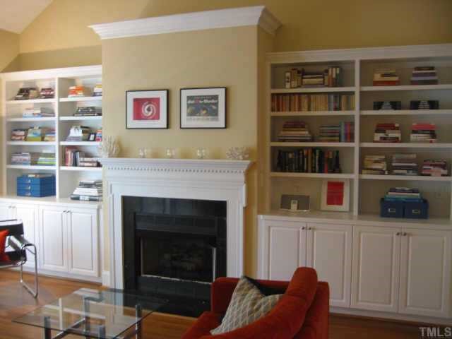 820 Running Brook Trail Raleigh, NC 27609 - Photo 3 of 10 Large family room with vaulted ceiling, gas-log fireplace, built-in bookcases and access to the deck.