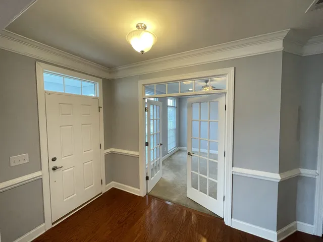 a view of entryway with wooden floor and stairs