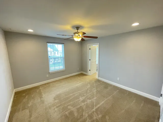 a view of a livingroom with a ceiling fan and window