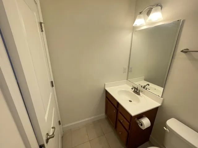 en empty room with windows and chandelier fan